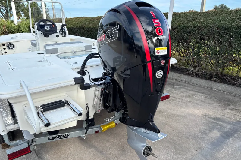 Slide: The Image of 2026 Mako 18 Pro Skiff boat with powerful 150 HP outboard motor, parked on trailer. - 3