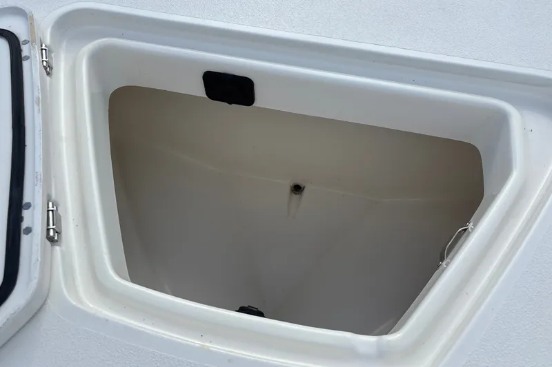 Slide: The Image of Open storage compartment on a 2026 Mako 18 Pro Skiff boat. - 16