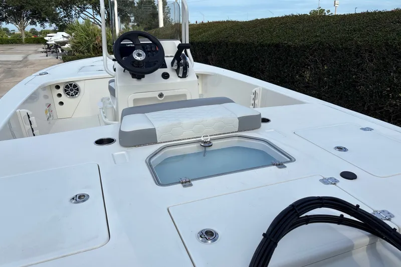Slide: The Image of 2026 Mako 18 Pro Skiff boat interior with steering wheel and seating. - 15
