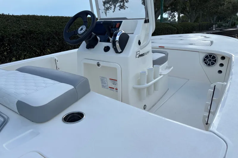 Slide: The Image of 2026 Mako 18 Pro Skiff boat interior with steering console and seating. - 11