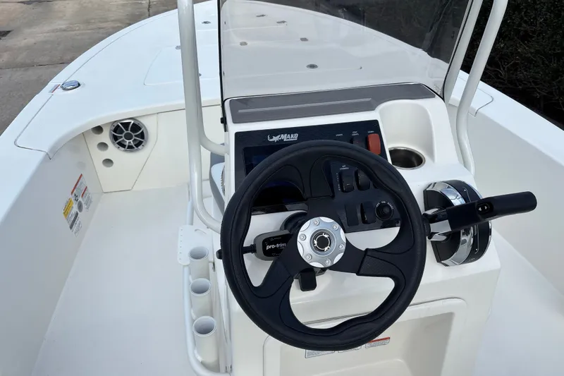 Slide: The Image of 2026 Mako 18 Pro Skiff boat console with steering wheel and controls. - 12
