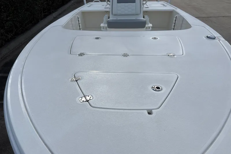Slide: The Image of 2026 Mako 18 Pro Skiff boat deck with storage compartments. - 8