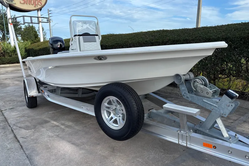 Slide: The Image of 2026 Mako 18 Pro Skiff on trailer, parked outdoors, showcasing sleek design. - 5