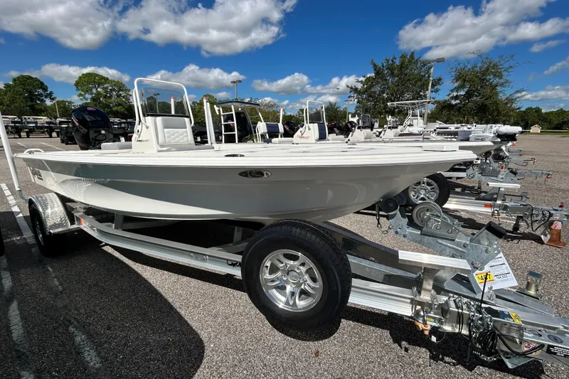 The Image of 2026 Mako 18 Pro Skiff boat on trailer under blue sky. - 0
