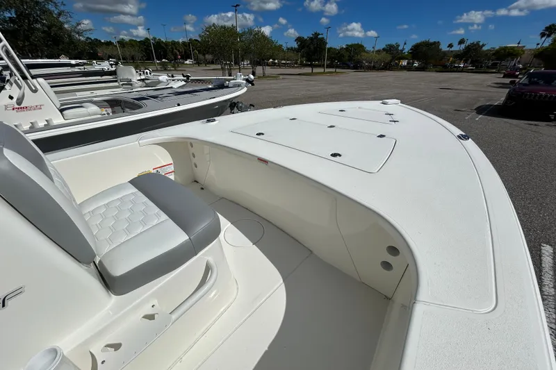 Slide: The Image of 2026 Mako 18 Pro Skiff boat interior with seating and storage compartments. - 2