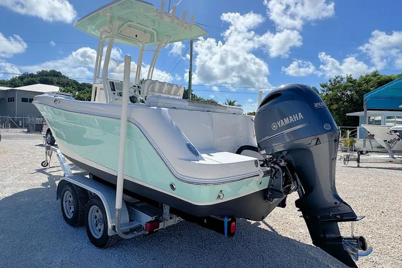 Slide: The Image of 2016 Robalo R222 Center Console boat with Yamaha engine on trailer, under clear blue sky. - 3