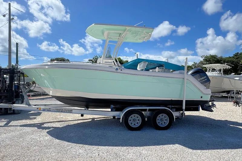 Slide: The Image of 2016 Robalo R222 Center Console boat on trailer under blue sky. - 4