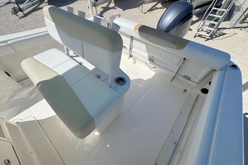 Slide: The Image of 2016 Robalo R222 Center Console boat interior with seating and engine view. - 5
