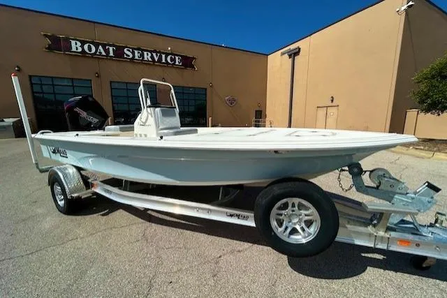 The Image of 2026 Mako 18 Pro Skiff boat on trailer outside boat service center. - 0