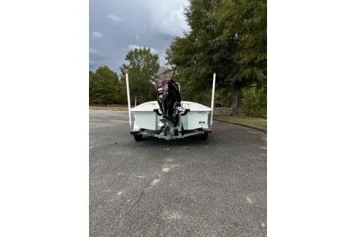 Slide: The Image of 2026 Mako 18 Pro Skiff boat on pavement, surrounded by trees. - 3