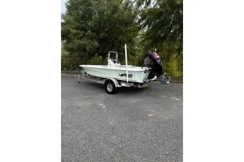 Slide: The Image of 2026 Mako 18 Pro Skiff boat on trailer, parked outdoors. - 4