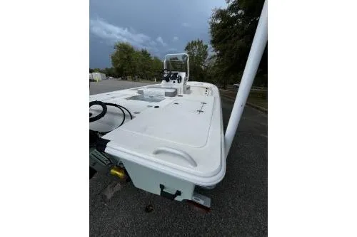 Slide: The Image of 2026 Mako 18 Pro Skiff boat, white deck, parked outdoors, overcast sky. - 5