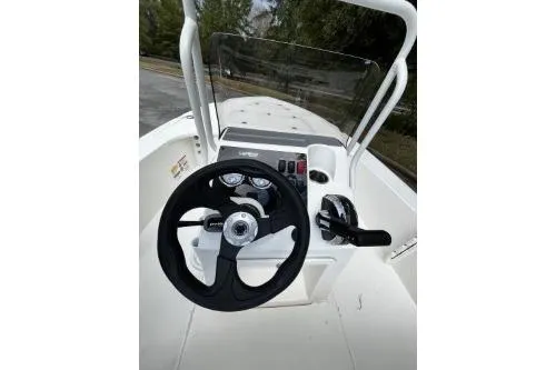 Slide: The Image of 2026 Mako 18 Pro Skiff boat console with steering wheel and controls. - 6