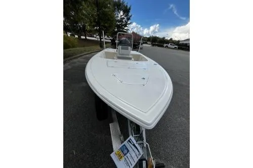 Slide: The Image of 2026 Mako 18 Pro Skiff boat on trailer, parked outdoors under blue sky. - 7