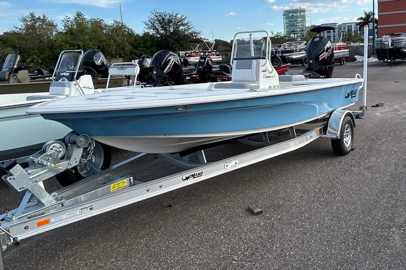 The Image of 2026 Mako 18 Pro Skiff boat on trailer, displayed outdoors. - 0
