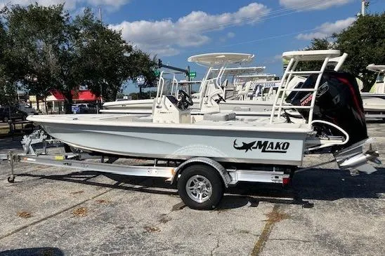 The Image of 2026 Mako 18 Pro Skiff boat on trailer, parked outdoors under a clear sky. - 0