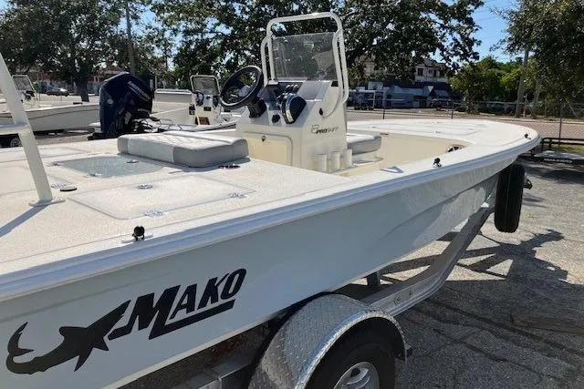 Slide: The Image of 2026 Mako 18 Pro Skiff boat on trailer, featuring center console and spacious deck. - 3