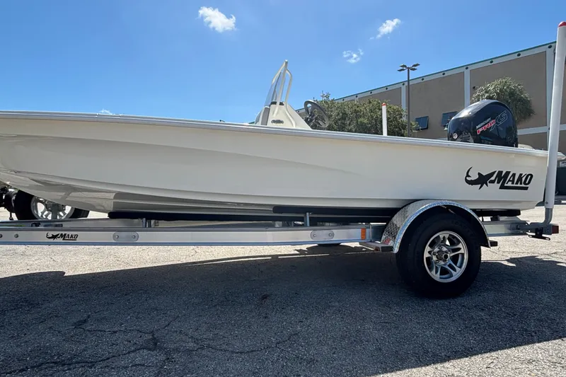 Slide: The Image of 2026 Mako 18 Pro Skiff boat on trailer under clear blue sky. - 3