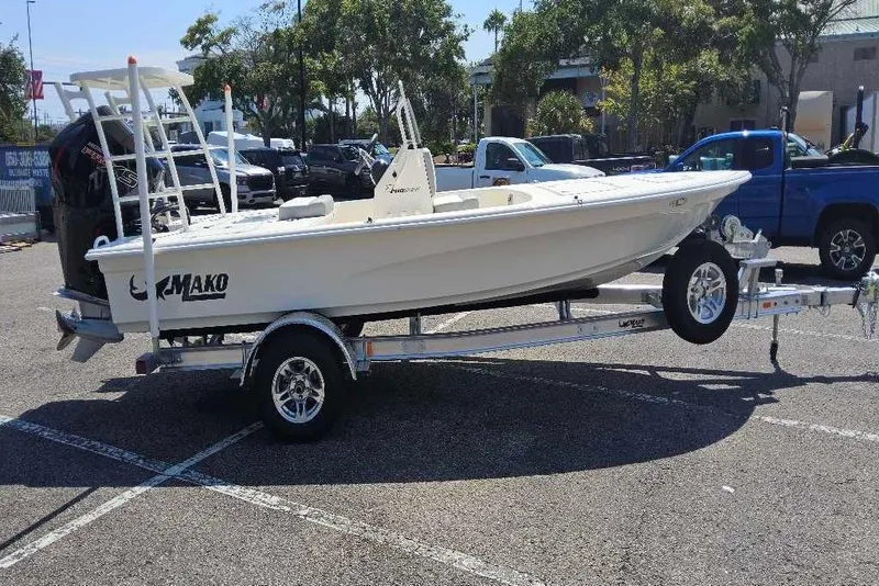 The Image of 2026 Mako Pro Skiff 18 boat on trailer in parking lot, sunny day. - 0