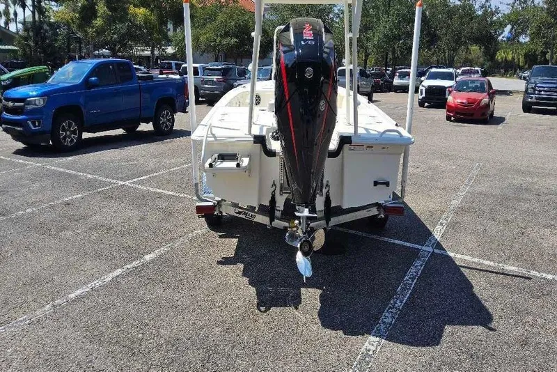 Slide: The Image of 2026 Mako Pro Skiff 18 boat with outboard motor in parking lot. - 6