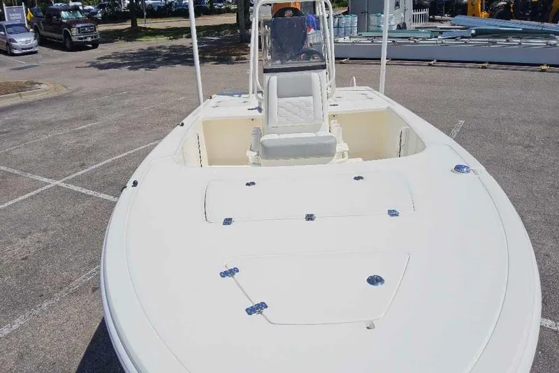 Slide: The Image of 2026 Mako Pro Skiff 18 boat in a parking lot, showcasing spacious deck design. - 2