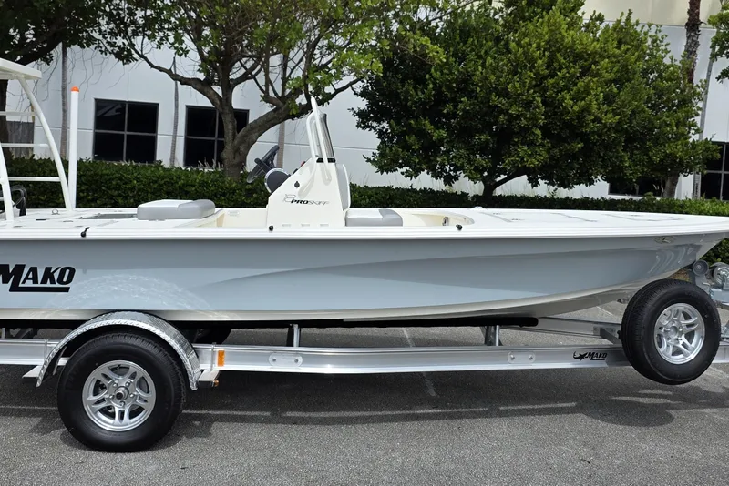 Slide: The Image of 2026 Mako 18 Pro Skiff boat on trailer, parked outdoors. - 1