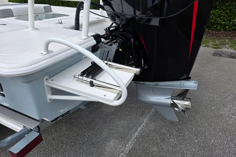 Slide: The Image of 2026 Mako 18 Pro Skiff boat with motor and foldable swim ladder. - 11