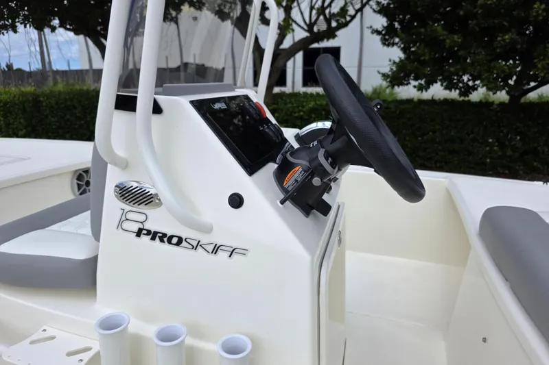 Slide: The Image of 2026 Mako 18 Pro Skiff boat console with steering wheel and seating. - 5