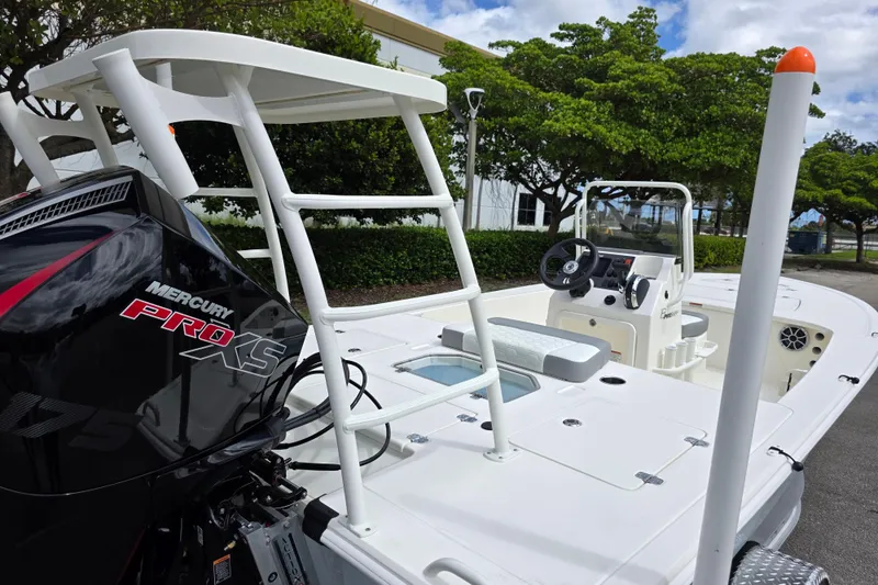 Slide: The Image of 2026 Mako 18 Pro Skiff boat with Mercury Pro XS engine, docked outdoors. - 6