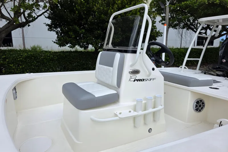 Slide: The Image of 2026 Mako 18 Pro Skiff boat interior with seating and steering console. - 8