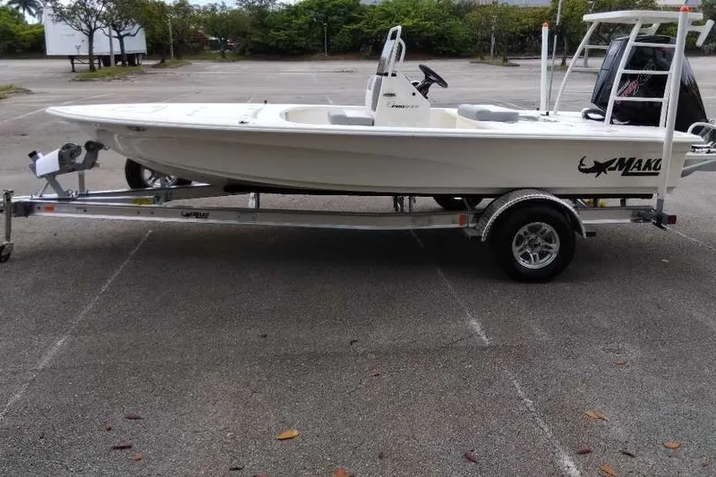 The Image of 2026 Mako 18 Pro Skiff boat on trailer in parking lot. - 0