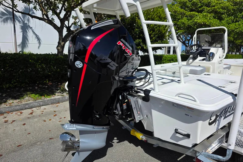 Slide: The Image of 2026 Mako 18 Pro Skiff with powerful outboard motor, parked outdoors. - 12