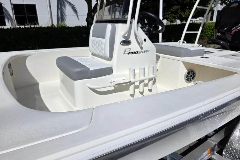 Slide: The Image of 2026 Mako 18 Pro Skiff boat interior with seating and rod holders. - 4