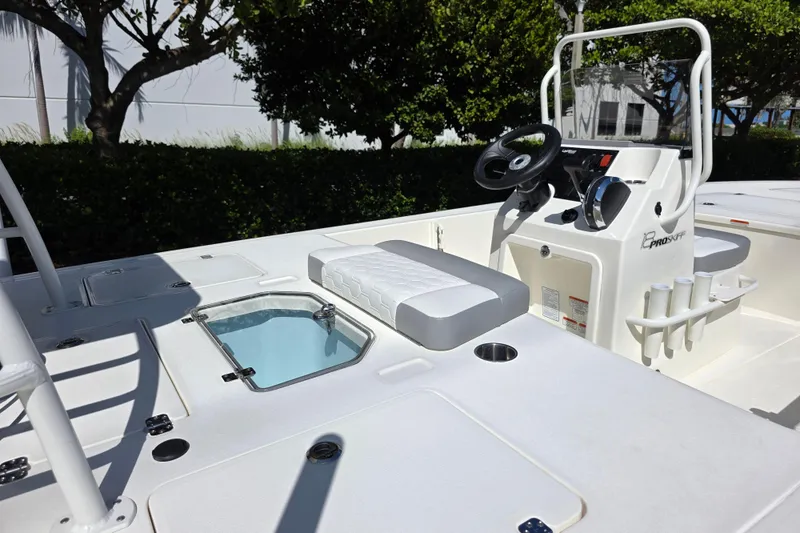 Slide: The Image of 2026 Mako 18 Pro Skiff boat interior with steering console and seating. - 8