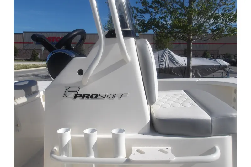 Slide: The Image of 2026 Mako 18 Pro Skiff boat interior with steering wheel and seating. - 22