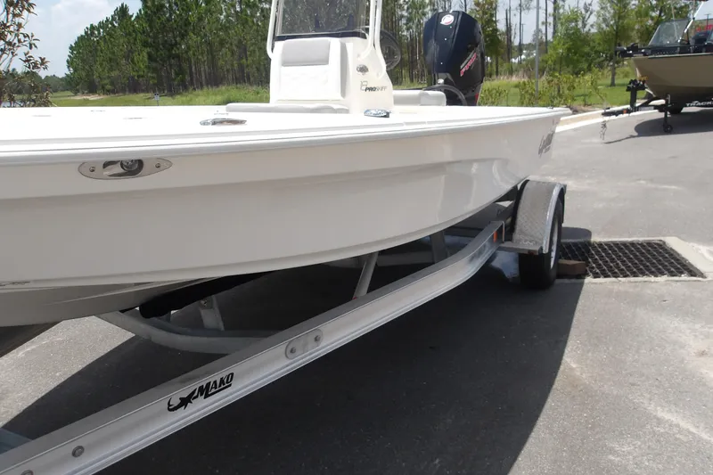 Slide: The Image of 2026 Mako 18 Pro Skiff boat on trailer, parked outdoors. - 14
