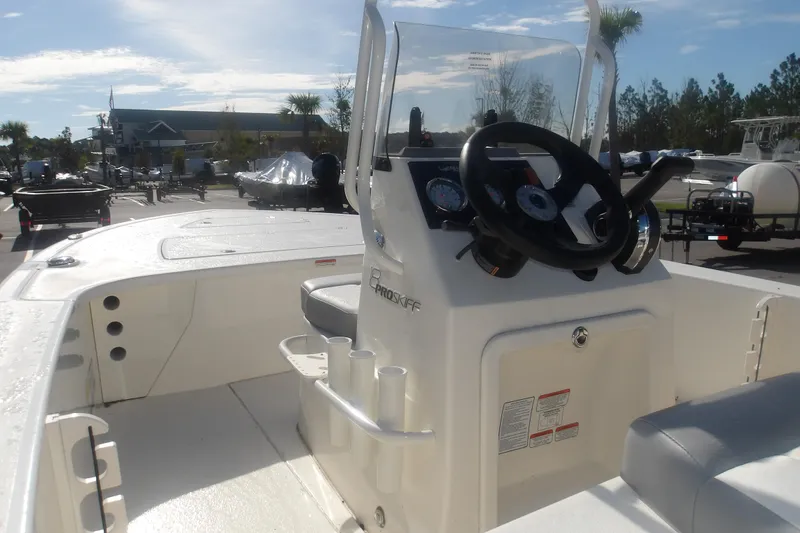 Slide: The Image of 2026 Mako 18 Pro Skiff boat interior with steering console and seating. - 20
