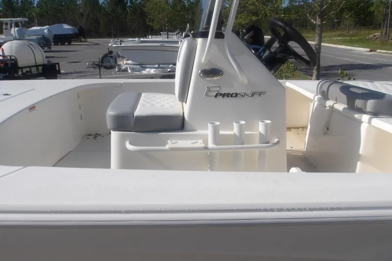 Slide: The Image of 2026 Mako 18 Pro Skiff boat interior with seating and steering console. - 19