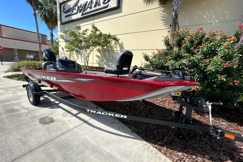 The Image of 2026 Tracker Pro 170 boat in red on a trailer, parked outdoors. - 0