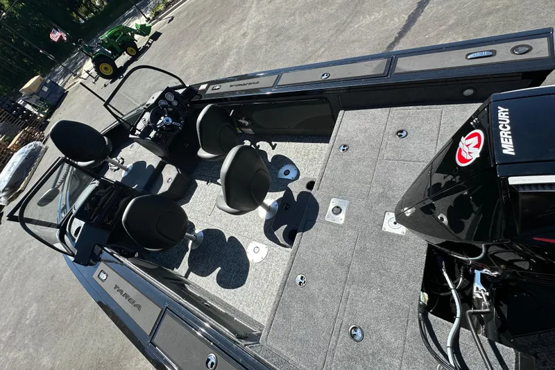Slide: The Image of 2026 Tracker Targa V-19 WT boat interior with seating and Mercury engine. - 2