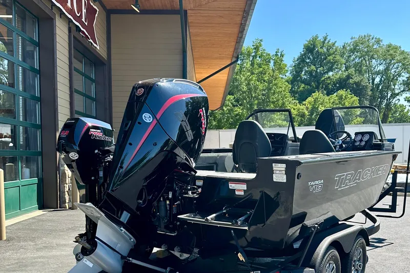 Slide: The Image of 2026 Tracker Targa V-19 WT boat with powerful Mercury outboard engines, parked outdoors. - 3