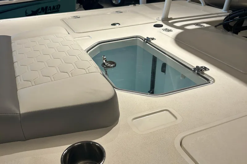 Slide: The Image of 2026 Mako 18 Pro Skiff steering console with controls and steering wheel. - 2