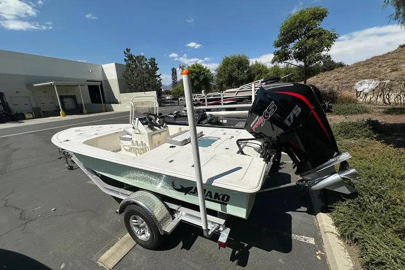 Slide: The Image of 2026 Mako Pro Skiff 18 boat with powerful engine, parked outdoors on a trailer. - 3