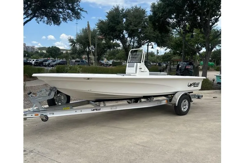 Slide: The Image of 2026 Mako Pro Skiff 18 boat on trailer, parked outdoors under clear sky. - 52