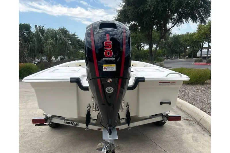 Slide: The Image of 2026 Mako Pro Skiff 18 with 150 HP engine, parked outdoors. - 54