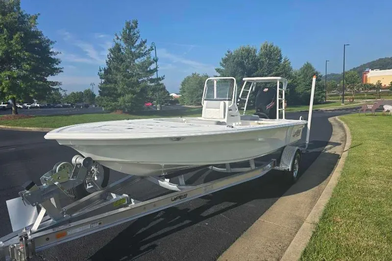 Slide: The Image of 2026 Mako 18 Pro Skiff boat on trailer, parked on a sunny day. - 3