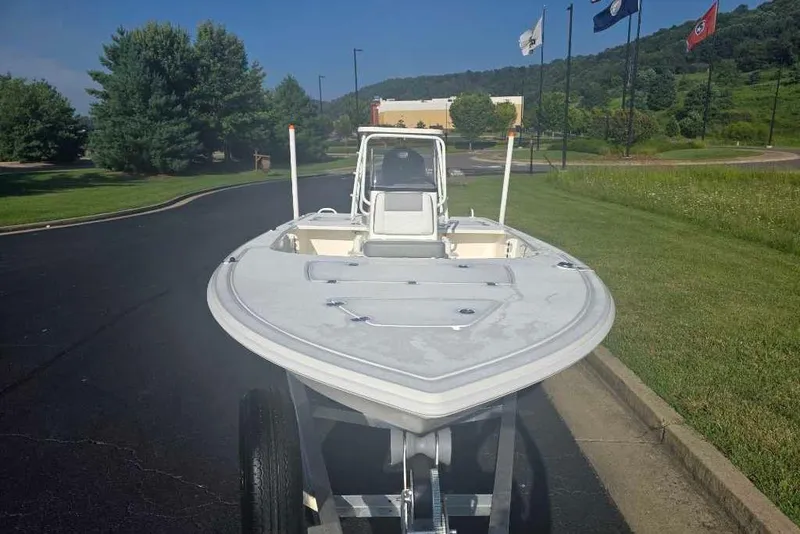 Slide: The Image of 2026 Mako 18 Pro Skiff boat on trailer, parked on a scenic road. - 6
