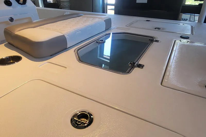 Slide: The Image of 2026 Mako Pro Skiff 18 boat interior with cushioned seating and storage compartments. - 3