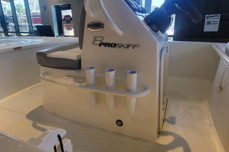 Slide: The Image of 2026 Mako Pro Skiff 18 interior with rod holders and steering console. - 4