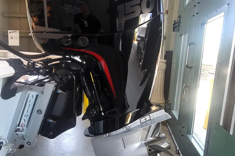 Slide: The Image of Outboard motor on a 2026 Mako Pro Skiff 18, indoors with reflective surface. - 5
